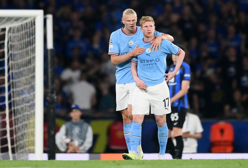 Kevin De Bruyne is consoled by Erling Haaland. Getty