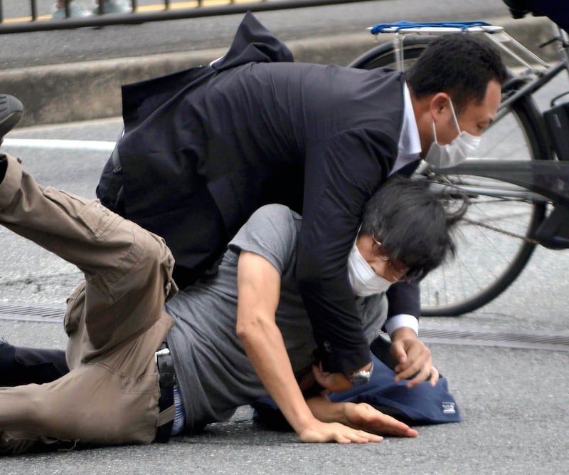 Tetsuya Yamagami is apprehended near the site of the fatal shooting of Shinzo Abe in Nara, western Japan. AP