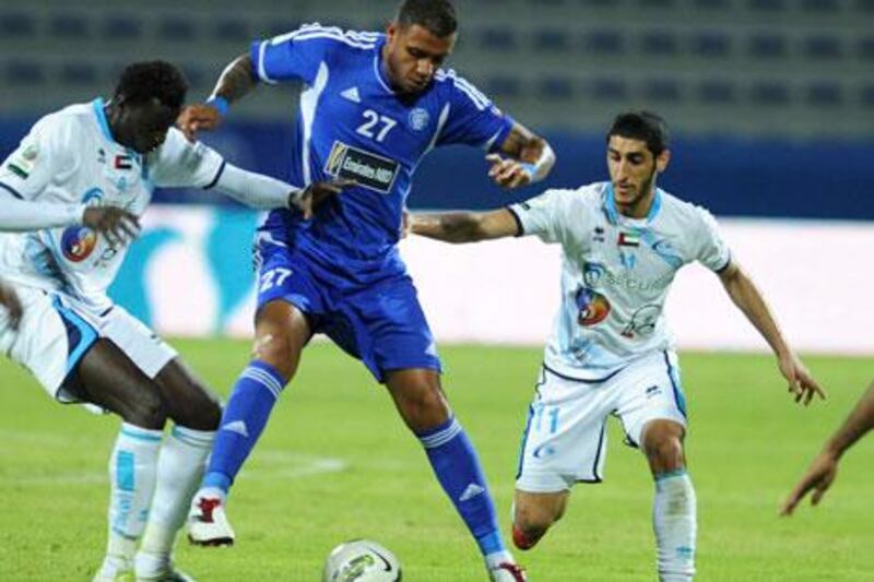 Linardo Lima of Al Nasr finds himself surrounded by Baniyas players. Al Nasr got two goals from Mark Bresciano to win Saturday night.