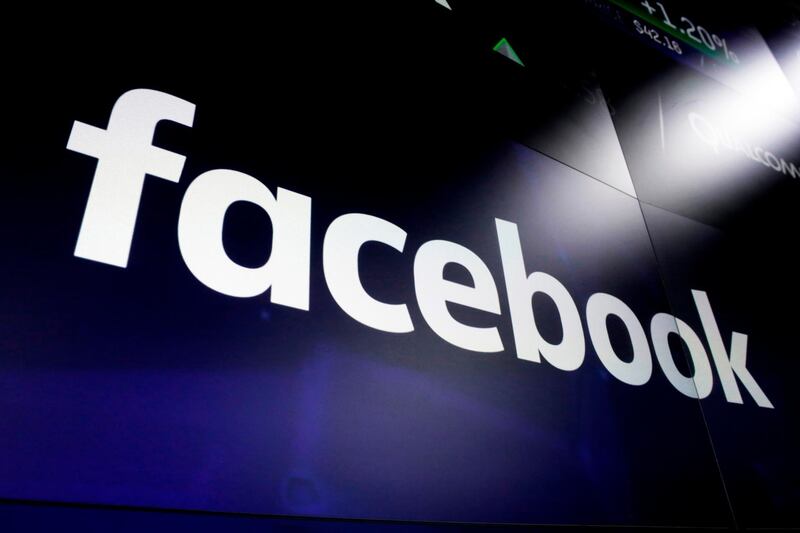 FILE - This March 29, 2018, file photo shows the Facebook logo on screens at the Nasdaq MarketSite in New York's Times Square. Facebook on Tuesday, April 28, 2020, reported its slowest quarterly growth as a public company, pressured by a global slowdown in the digital advertising market due to the coronavirus pandemic. (AP Photo/Richard Drew, File)