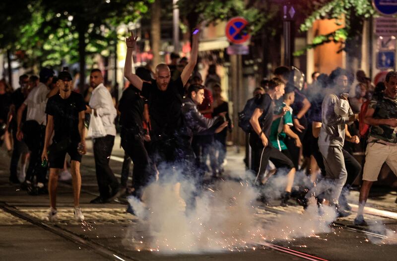 Protestors flee from an exploding firework on a street in Nice, during the fifth night of rioting on July 2.  AFP