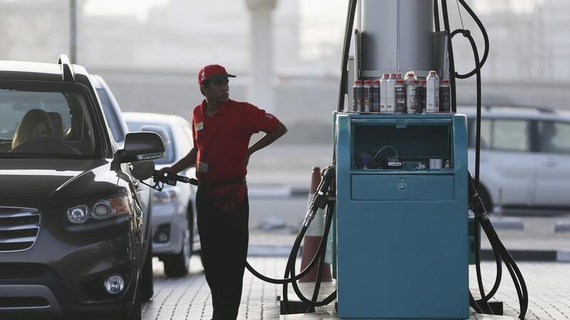 A petrol station worker fill a motorist’s tank in Dubai. Kamran Jebreili / AP Photo