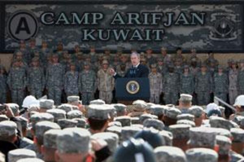 George W Bush, the US president, addresses military personnel at the  camp.