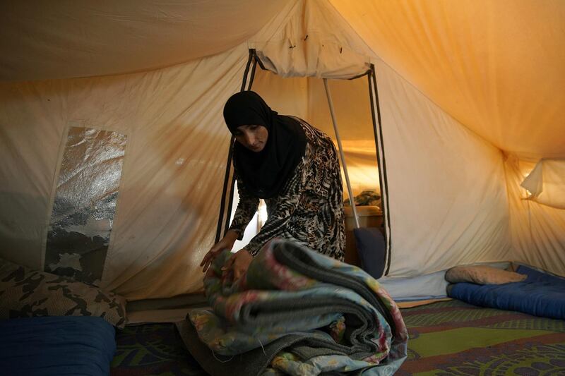 A displaced Iraqi woman packs her belongings as she prepares to be evacuated from the Hammam Al Alil camp south of Mosul in Nineveh province. Reuters