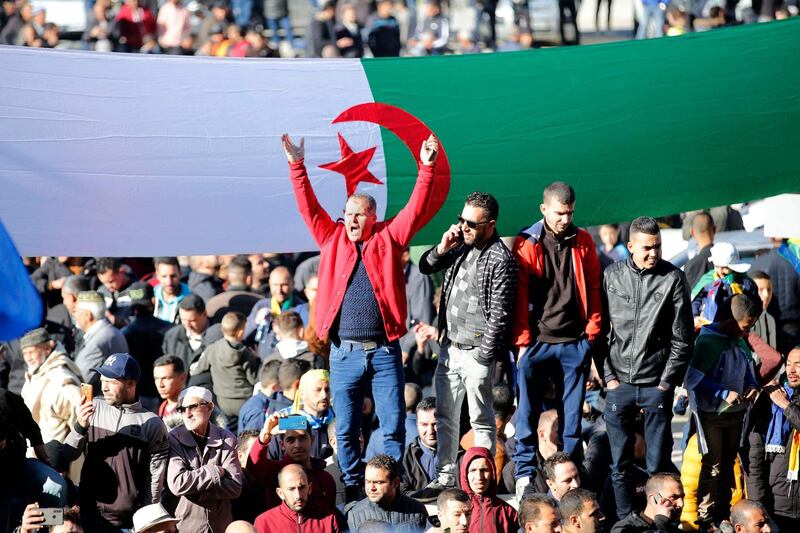 Algerians rally in the northern town of Kherrata marking some of the first Hirak protests on February 16, 2021, two years into the mass movement which swept former strongman Abdelaziz Bouteflika from power. Defying coronavirus restrictions and an outright ban on protests, "hundreds of demonstrators gathered in the city centre" of Kherrata, seen as the movement's birthplace. / AFP / -
