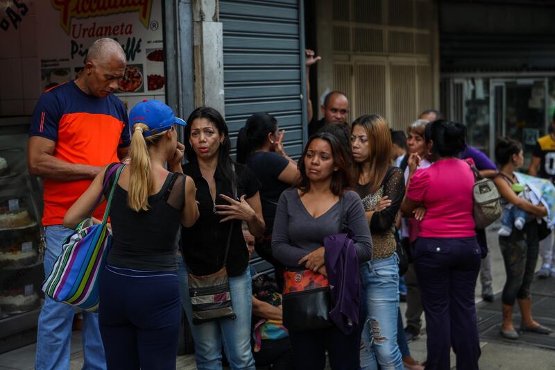 epa06814287 Relatives of victims of the stampede in the Social Club El Paraiso react in front of the headquarters of the Scientific Police (Cicpc), in Caracas, Venezuela, 16 June 2018. Interior Minister of Venezuela Nestor Reverol confirmed that at least 17 people were killed after a tear gas canister was set off triggering a stampede at a nightclub as hundreds tried to escape the fumes. Most of the clubgoers were teenagers celebrating high school graduation.  EPA/CRISTIAN HERNANDEZ