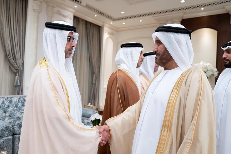 ABU DHABI, UNITED ARAB EMIRATES - June 04, 2019: HH Sheikh Hamed bin Zayed Al Nahyan, Chairman of the Crown Prince Court of Abu Dhabi and Abu Dhabi Executive Council Member (L), greets a guest during an Eid Al Fitr reception at Mushrif Palace. Seen with HH Sheikh Mansour bin Zayed Al Nahyan, UAE Deputy Prime Minister and Minister of Presidential Affairs (2nd L).

( Mohamed Al Hammadi / Ministry of Presidential Affairs )
---