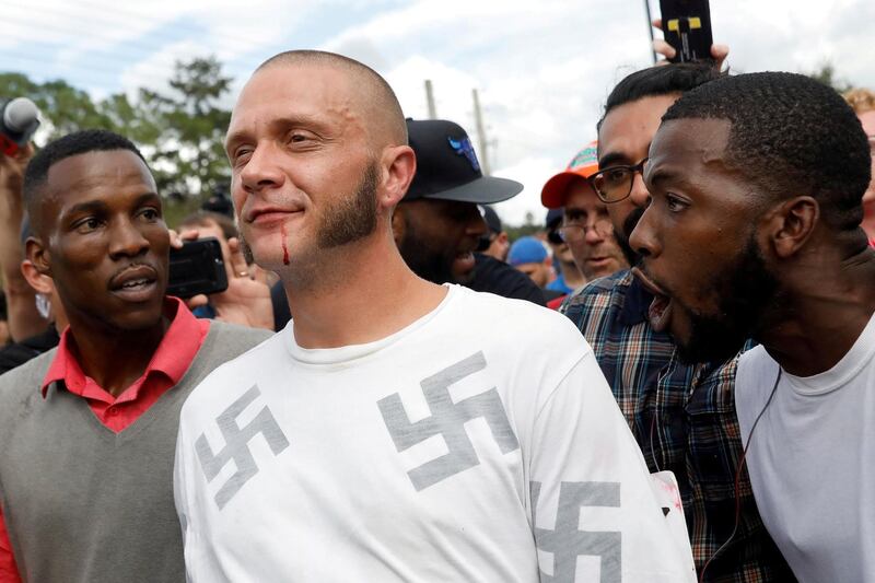 A Nazi walks with a bloody lip as demonstrators yell at him  on the campus of the University of Florida in Gainesville. Shannon Stapleton / Reuters / October 19, 2017