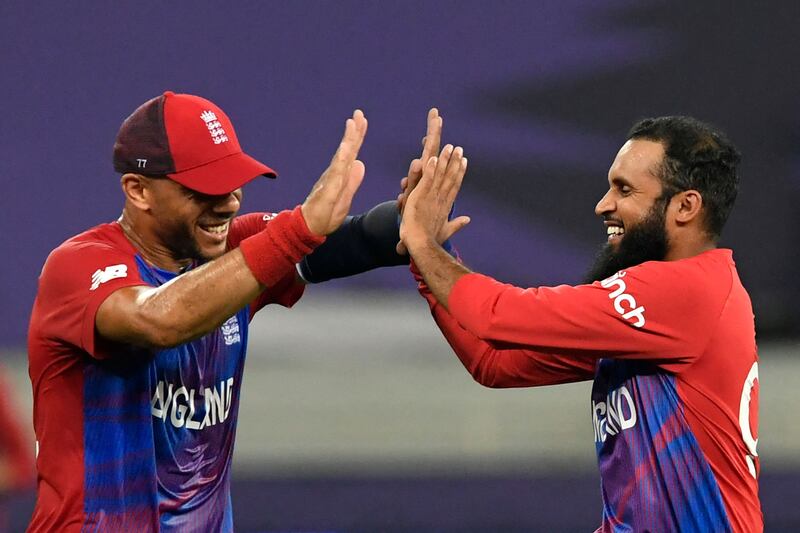 England's Adil Rashid, right, celebrates with teammate Tymal Mills after taking the wicket of West Indies' Obed McCoy. AFP