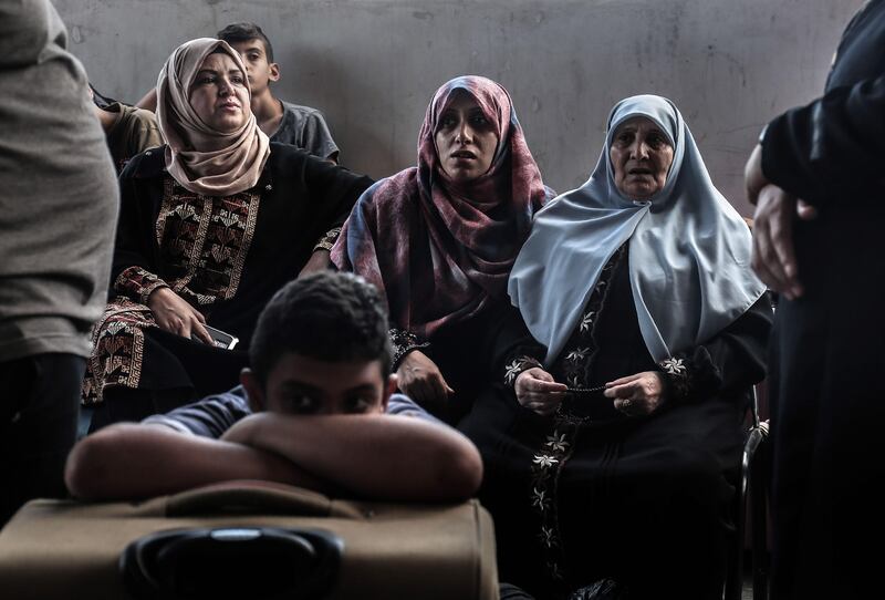 Palestinians wait for travel permits to cross into Egypt through the Rafah border crossing on August 16, 2017. Said Khatib / AFP Photo