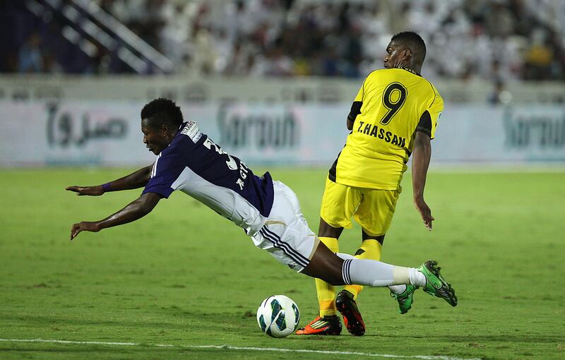 
AL AIN , UNITED ARAB EMIRATES Ð Nov 3 : Asamoah Gyan ( no 3 in blue ) of Al Ain and Tariq Hassan ( no 9 in yellow ) of Al Wasl in action during the etisalat pro - league football match between Al Ain vs Al Wasl club at Tahnoun Bin Mohammed Stadium in Al Ain. ( Pawan Singh / The National ) For Sports.