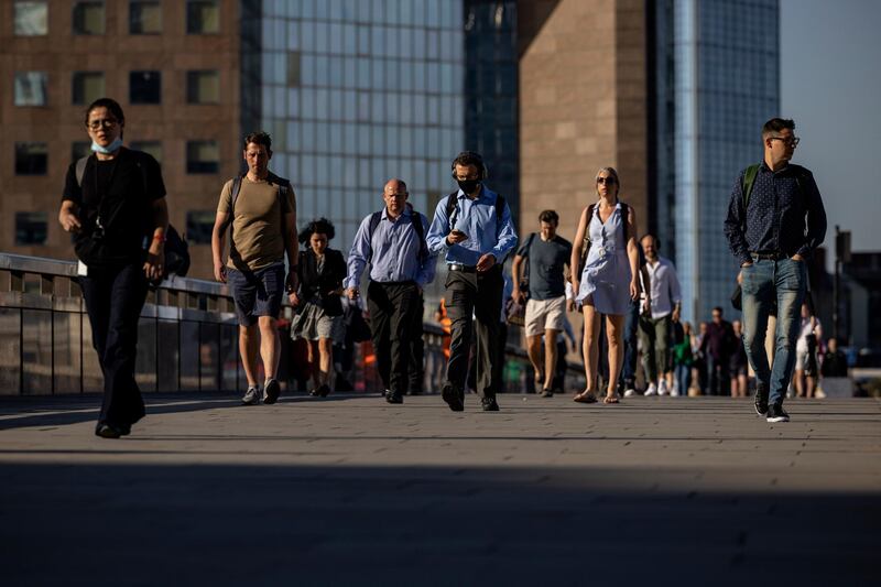 Morning commuters cross London Bridge in London. British officials have raised concern over the coronavirus Delta variant and rising infection rates. Getty Images