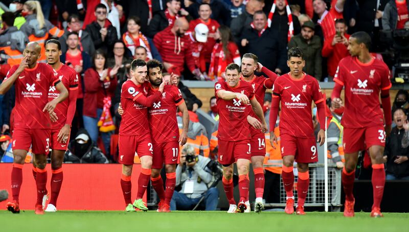 Liverpool's Mohamed Salah celebrates with teammates after scoring their second goal. Reuters