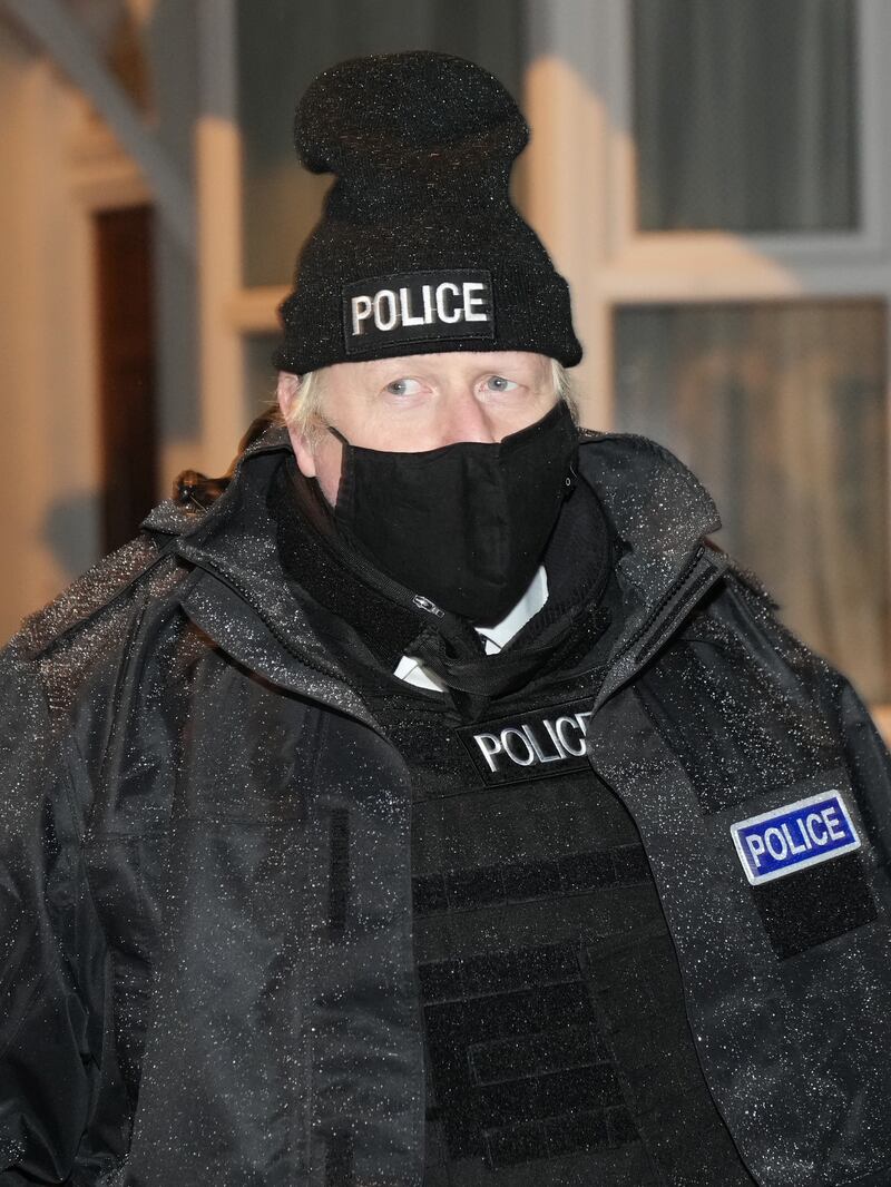 Mr Johnson observes an early morning Merseyside Police raid on a home in Liverpool as part of 'Operation Toxic' to infiltrate county lines drug dealings in December 2021. Getty Images