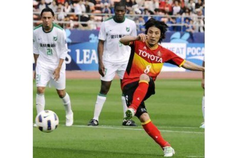 Jungo Fujimoto, the Nagoya Grampus midfielder, scores from the penalty spot against China's Hangzhou Greentown.