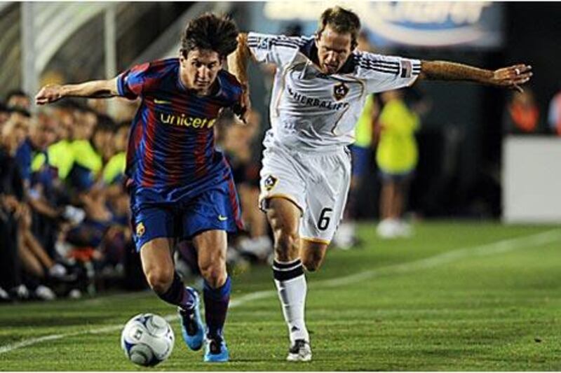 Lionel Messi, left, in action for Barcelona against the LA Galaxy during their recent tour to the United States.