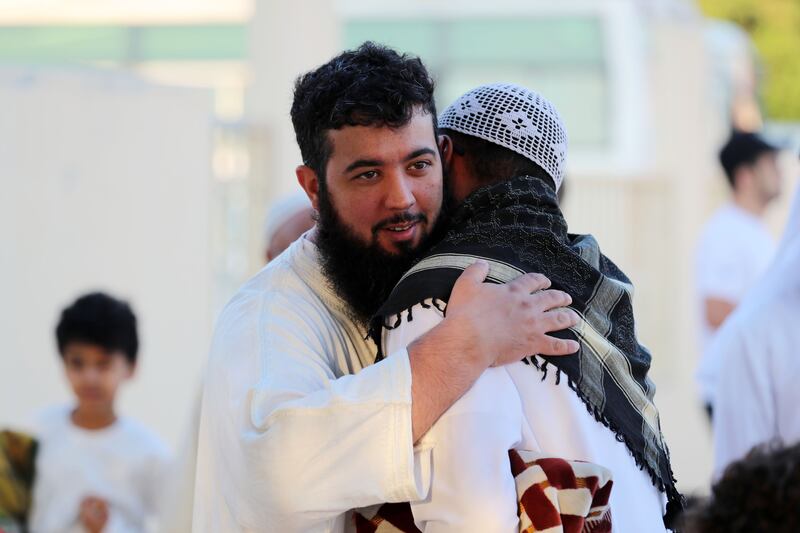 Muslims exchange Eid greetings after morning prayers on Friday. Chris Whiteoak / The National