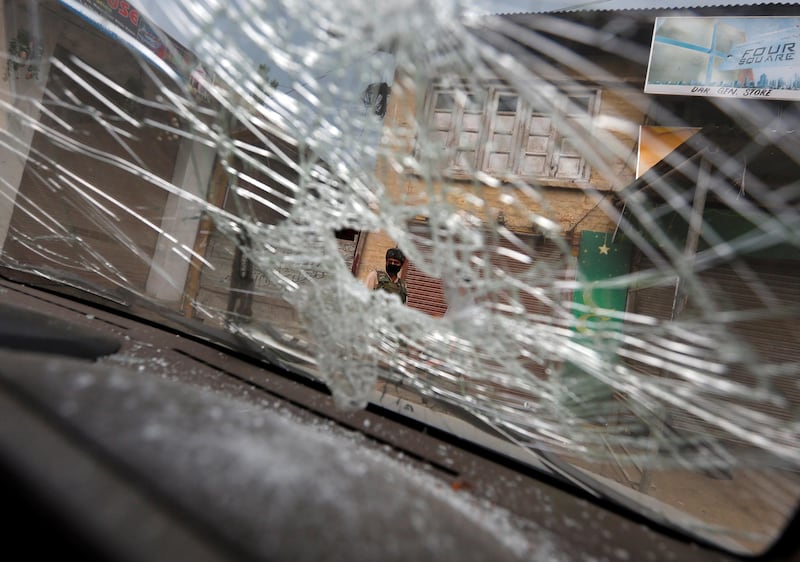 An Indian security force personnel is seen through the broken windshield of a vehicle in Boateng village in south Kashmir's Anantnag district, at the site of a gun battle between Indian police and militants, where seven Hindu pilgrims were killed. Reuters / Danish Ismail