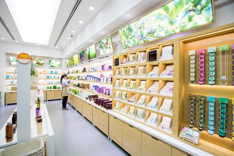 A store employee organizes products in a store of Innisfree, an Amorepacific Corp. cosmetic brand, at the Ngee Ann City shopping and commercial center in Singapore, on Tuesday, Sept. 12, 2017. South Korea's biggest cosmetics maker is revamping its products to suit Muslims and darker-skinned women in Southeast Asia as it tries to make up business lost because of political tensions with China over a missile-defense system. Photographer: Nicky Loh/Bloomberg