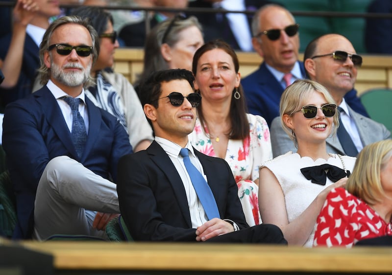 US actor Rami Malek, centre, and his girlfriend Lucy Boynton, right, attend the men's semi-final match between Novak Djokovic and Cameron Norrie. EPA