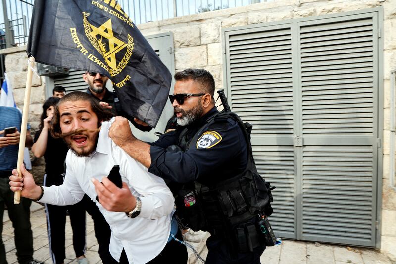 A policeman pushes an Israeli taking part in a gathering to mark Jerusalem Day. Reuters