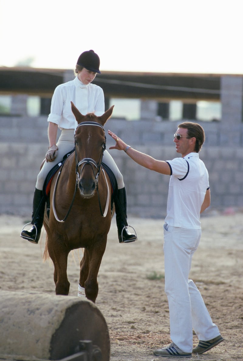 Princess Anne with her first husband, Captain Mark Phillips, at an equestrian event in Abu Dhabi in 1984. Getty Images