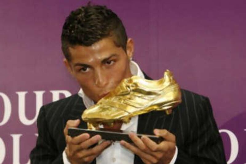 The Manchester United winger Cristiano Ronaldo kisses the Golden Boot trophy after being crowned Europe's most prolific marksman last season.