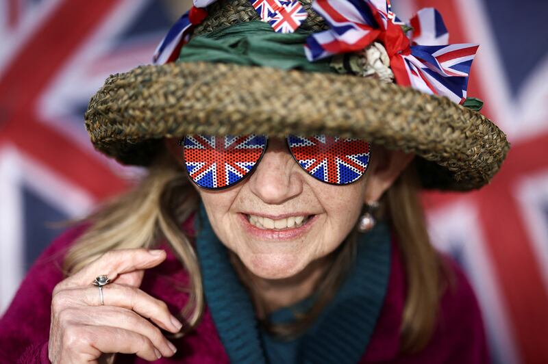 A royal fan gets into the spirit of the coronation on the Mall outside Buckingham Palace. Reuters