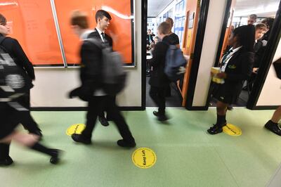 Social distancing signs are displayed on the floor as pupils return to school at Copley Academy in England. Getty.