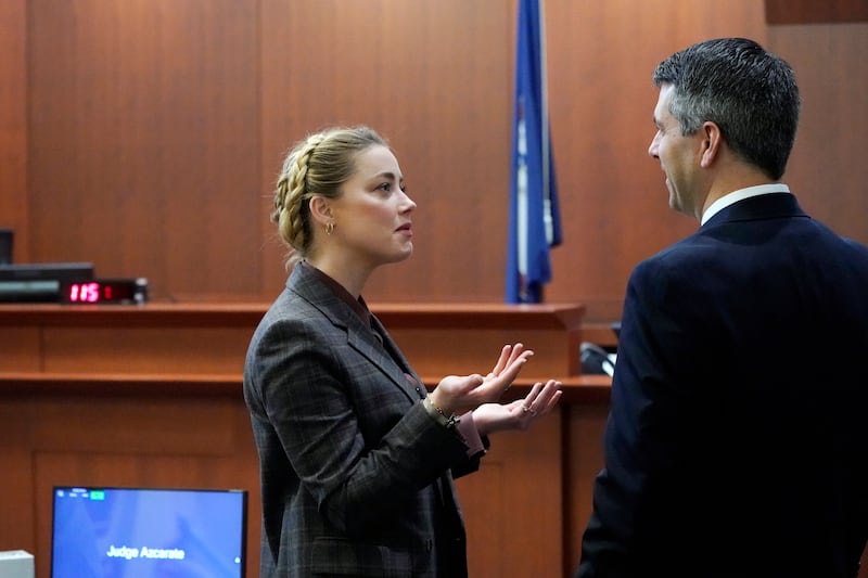 Actor Amber Heard talks to her attorney in the courtroom during a break. AP