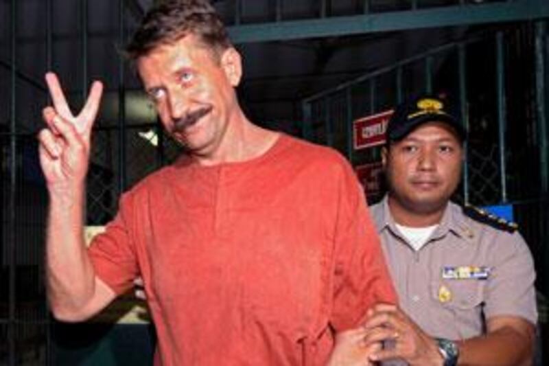 Viktor Bout shows a victory sign after his verdict at the criminal court in Bangkok.