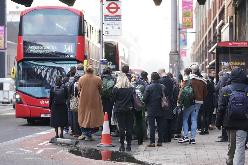 Passengers try to board a bus at Waterloo station in London, with the UK capital braced for a third day of travel misery caused by Tube strikes. PA