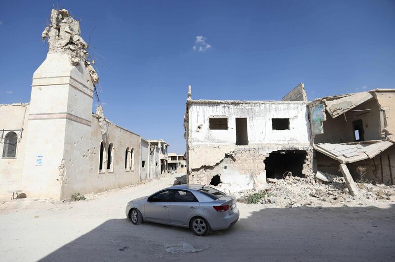 A Syrian motorist drives amidst ruins in Morek. AFP