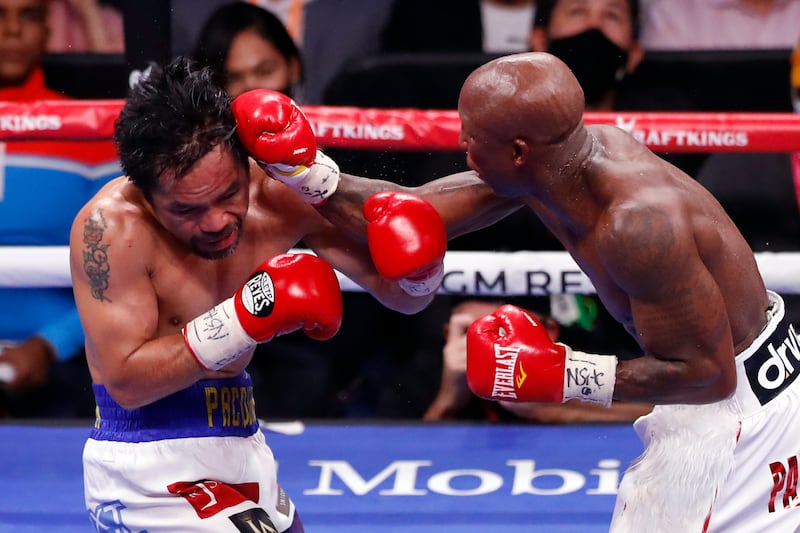 Yordenis Ugas lands a punch on Manny Pacquiao. AFP