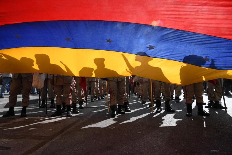 Members of the Bolivarian militia attend a march in support of Venezuelan President Nicolas Maduro with a Venezuelan national flag in Caracas.