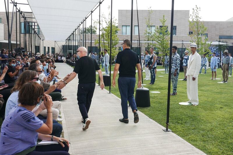 Italian fashion designers Domenico Dolce, right, and Stefano Gabbana walk after Dolce & Gabbana men Spring / Summer 2021 fashion collection show. AFP