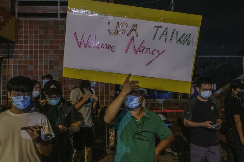 Supporters outside Songshan Airport welcome Ms Pelosi. Bloomberg