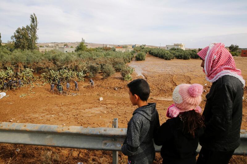 People watch as the search for the missing continues. Reuters