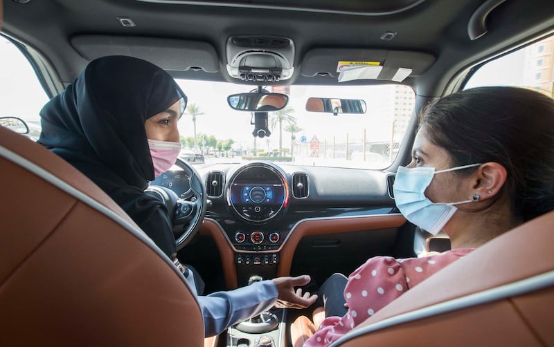 Dubai, United Arab Emirates - Instructor Sabia teaching a students pointers in driving at the Emirates Driving Institute, Dubai.  Leslie Pableo for The National