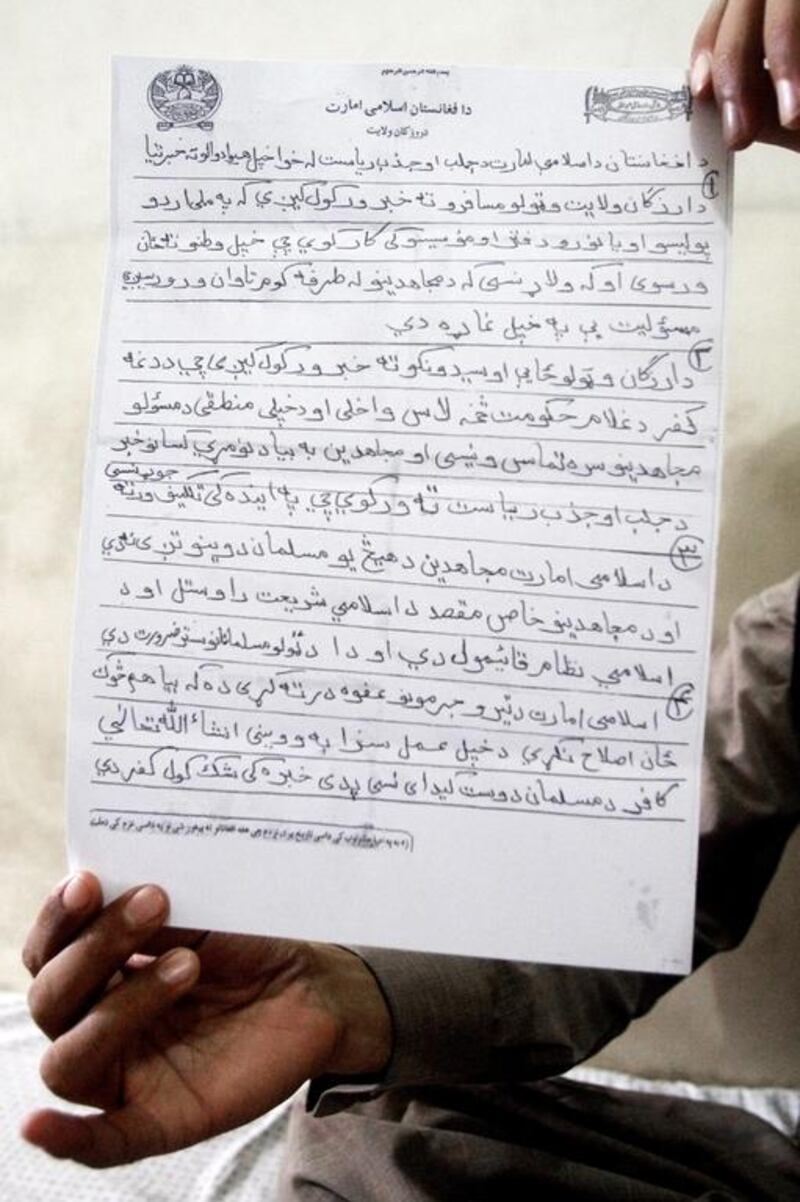 A man displays a forged letter written in Pashto, in Dand district, Kandahar province south of Kabul, Afghanistan. Threatening letters from the Taliban, once tantamount to a death sentence, are now being forged and sold to Afghans who want to start a new life in Europe.  Allauddin Khan/AP Photo