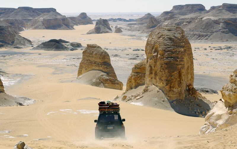 Desert safari vehicles drive along Aqabat desert near Farafra Oasis in Egypt. EPA