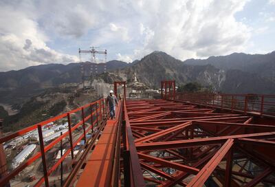 An engineer walks on an iron structure at the construction site of a railway bridge in Kouri in the Reasi district in Jammu-Kashmir. Reuters