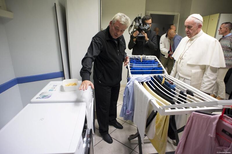 Pope Francis visits a shelter for the homeless outside the Vatican. Osservatore Romano / Reuters
