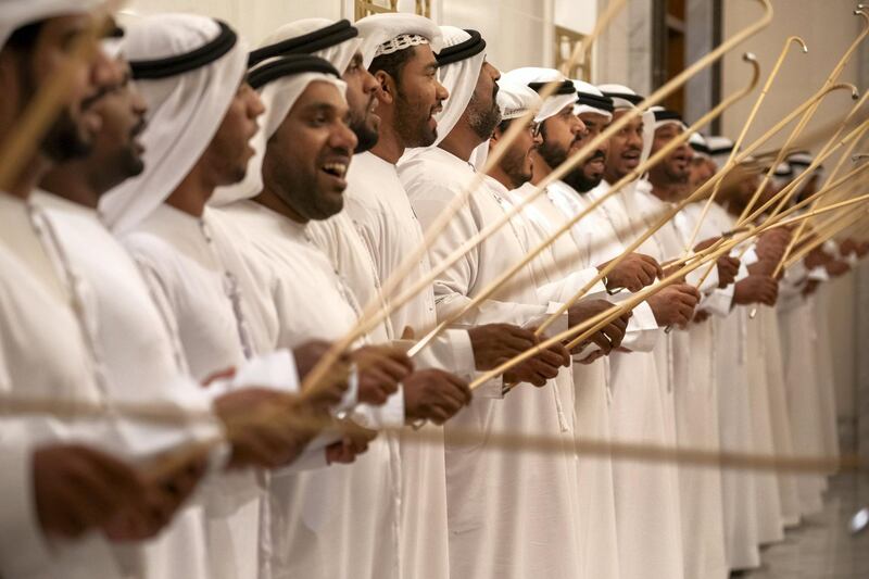 ABU DHABI, UNITED ARAB EMIRATES - February 3, 2019: Day one of the UAE papal visit - Men sing and dance during arrival of His Holiness Pope Francis, Head of the Catholic Church (not shown), and His Eminence Dr Ahmad Al Tayyeb, Grand Imam of the Al Azhar Al Sharif (not shown), at the Presidential Airport. 

( Ryan Carter / Ministry of Presidential Affairs )
---