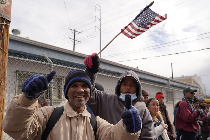 A migrant waves an American flag during a protest against the Title 42 immigration policy in El Paso. Willy Lowry / The National