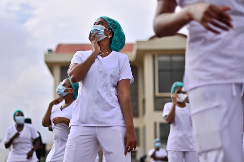 Nurses assigned to the Infectious Diseases Unit at the Kenyatta University Hospital dance during a Zumba class held at the hospital compound in Nairobi.  AFP
