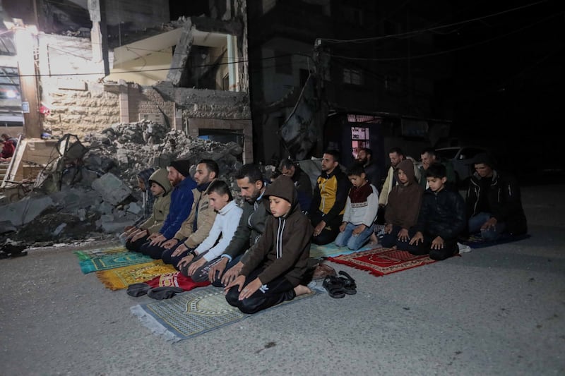 Palestinians pray taraweeh on the rubble of Rafah's Al Huda Mosque, which was destroyed in Israeli air strikes. Getty Images