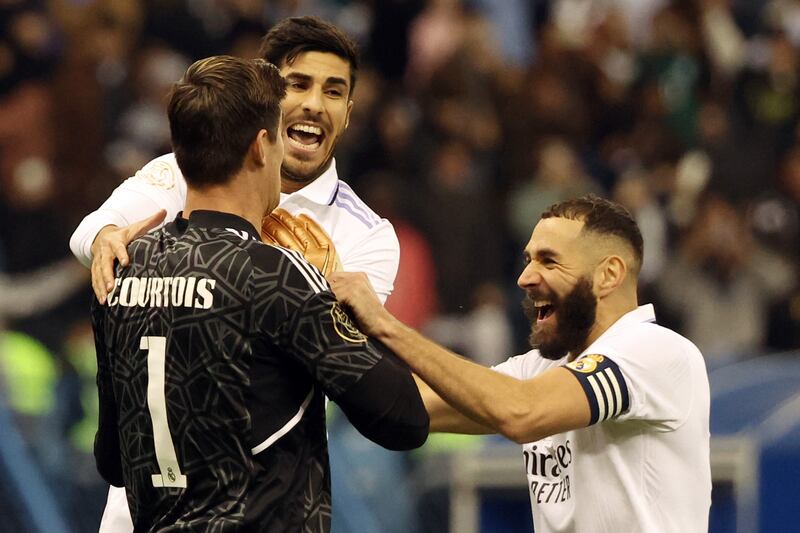 Real Madrid forward Karim Benzema, goalkeeper Thibaut Courtois and midfielder Marco Asensio celebrate after winning the Spanish Super Cup semi-final against Valencia at the King Fahd International Stadium in Riyadh, Saudi Arabia, on January 11, 2023. AFP