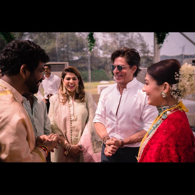 Shah Rukh Khan shares a light moment with the bride and groom.