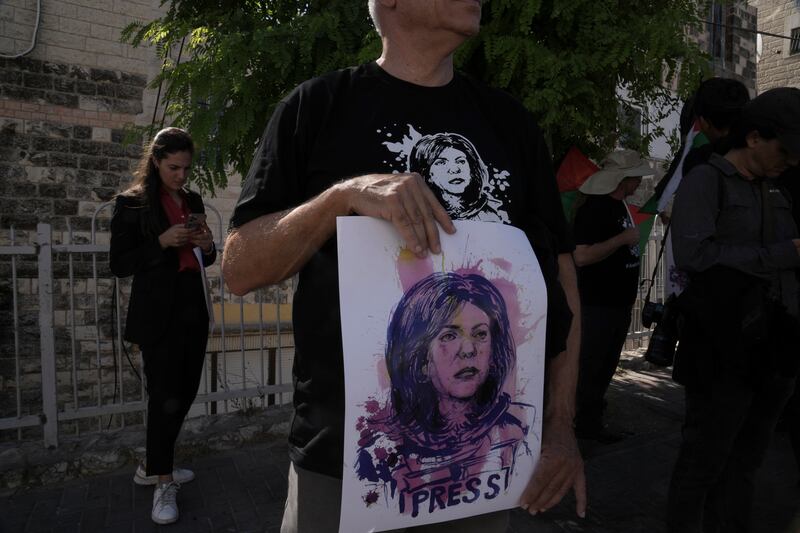 Protesters hold signs depicting Palestinian-American journalist Shireen Abu Akleh, who was killed in the West Bank earlier this year. AP